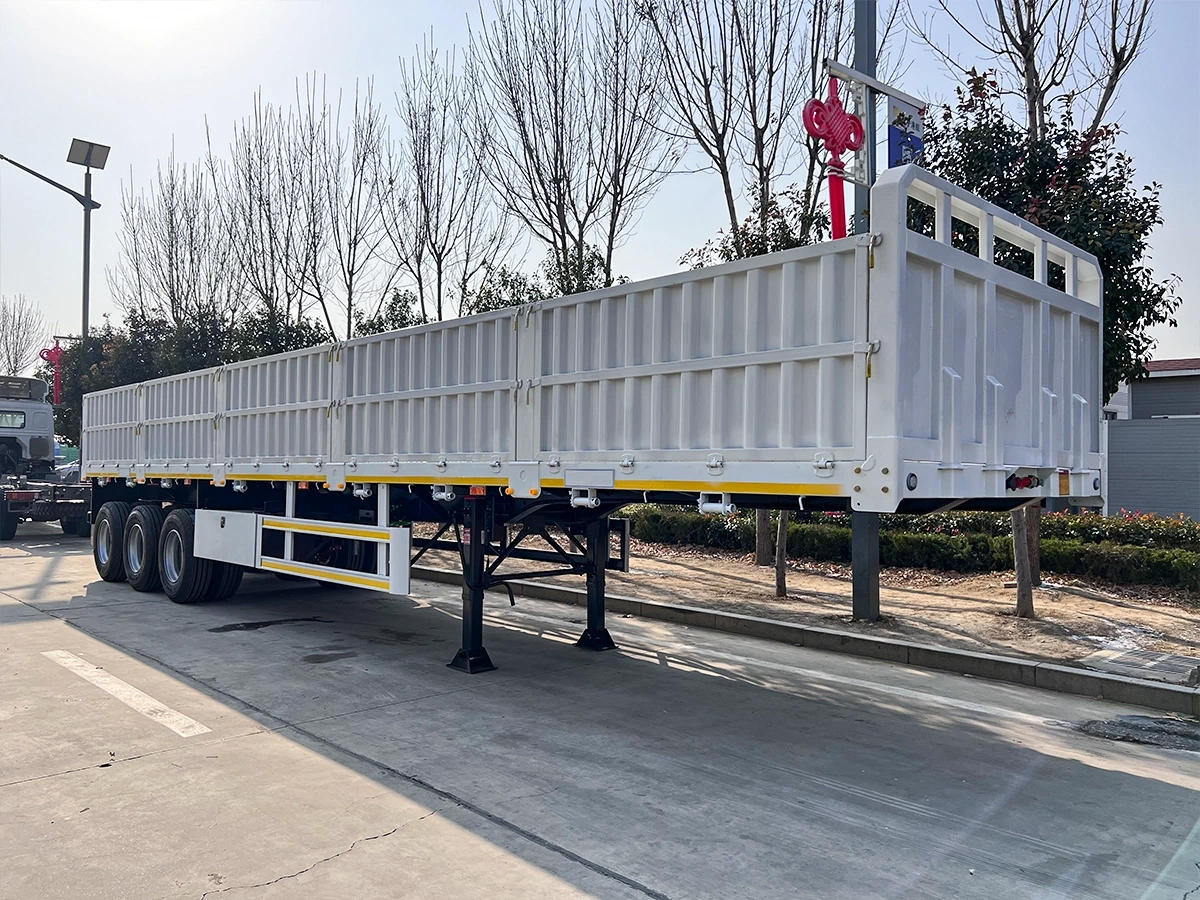 Heavy-duty side wall semi trailer being loaded at factory loading dock in Shandong China Heavy-duty side wall semi trailer being loaded at factory loading dock in Shandong China